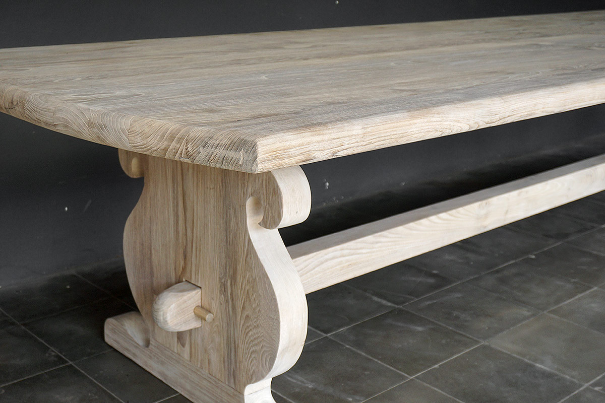 Detail of carved trestle leg and thick reclaimed teak top