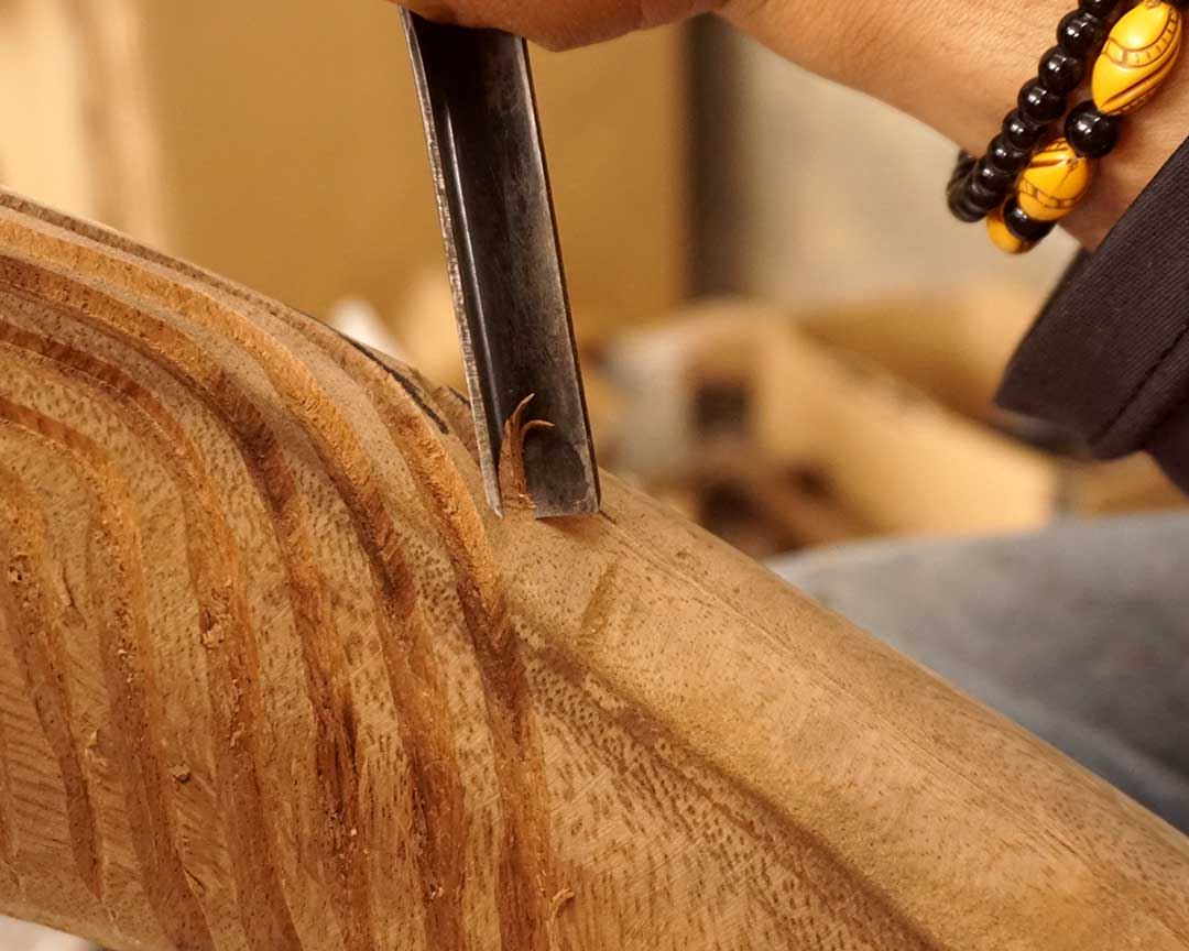 Close-up of chisel carving teak